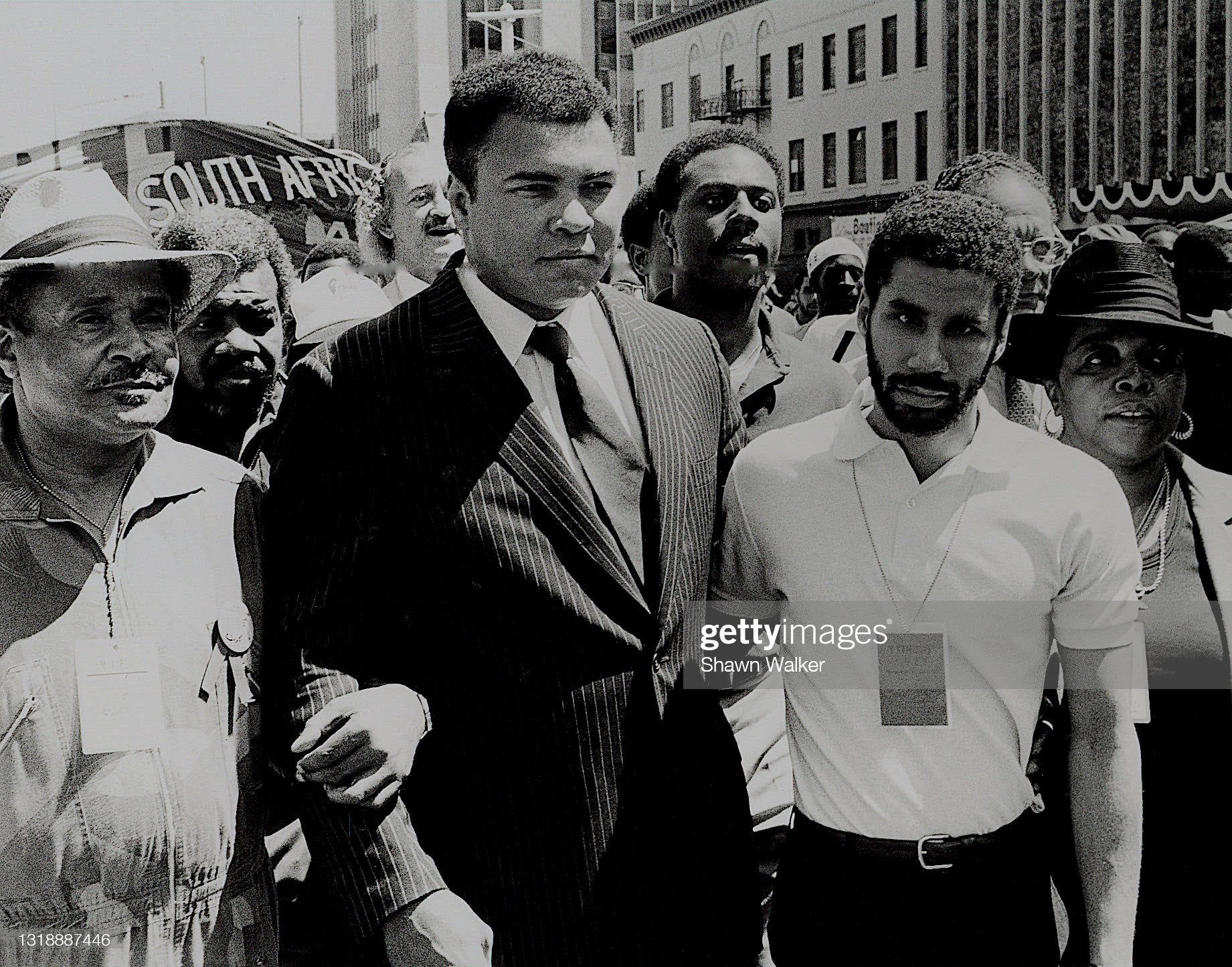 American heavy weight boxer Muhammad Ali (1942 – 2016) (center) and (future New York Governor) David Patterson (fore, right), among others, during a demonstration in support of South African freedom (near the intersection of 125th Street and 7th Avenue) in Harlem, New York, New York, 1982. (Photo by Shawn Walker/Getty Images)